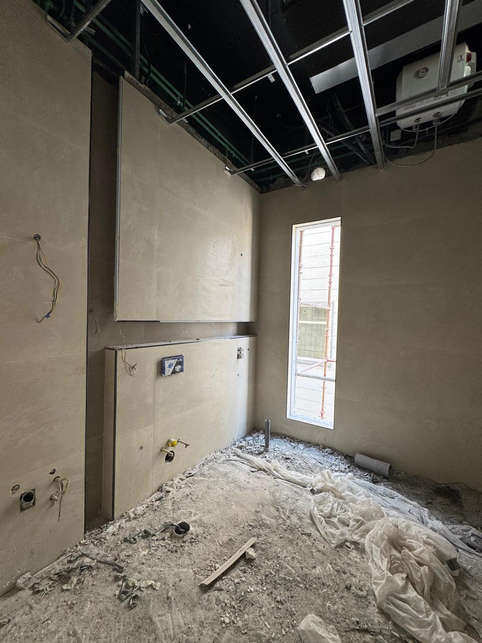 Plastered walls with MEP rough-in and ceiling grid