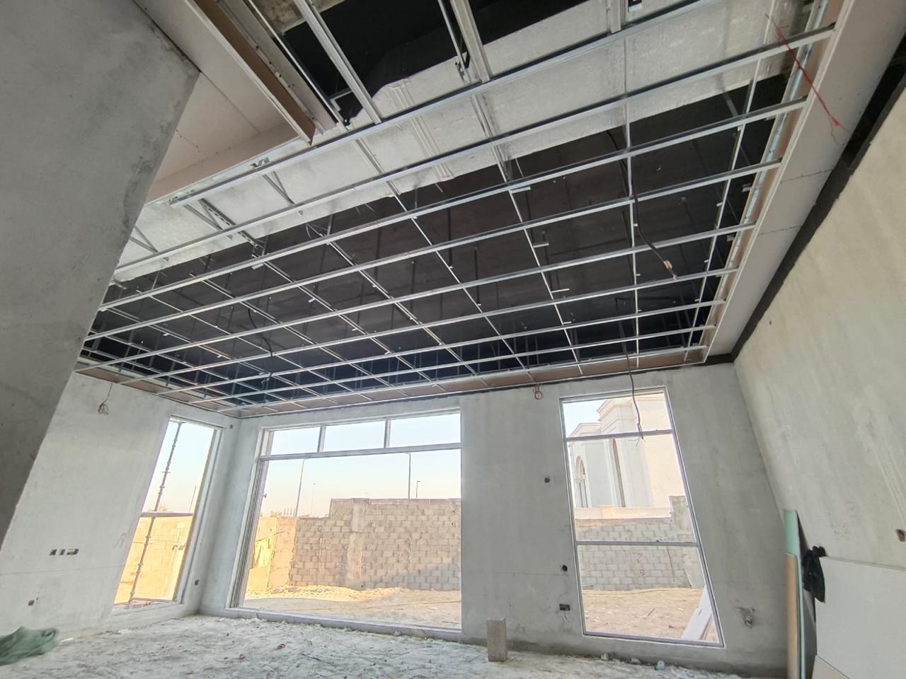 Ceiling grid framework in villa room with windows