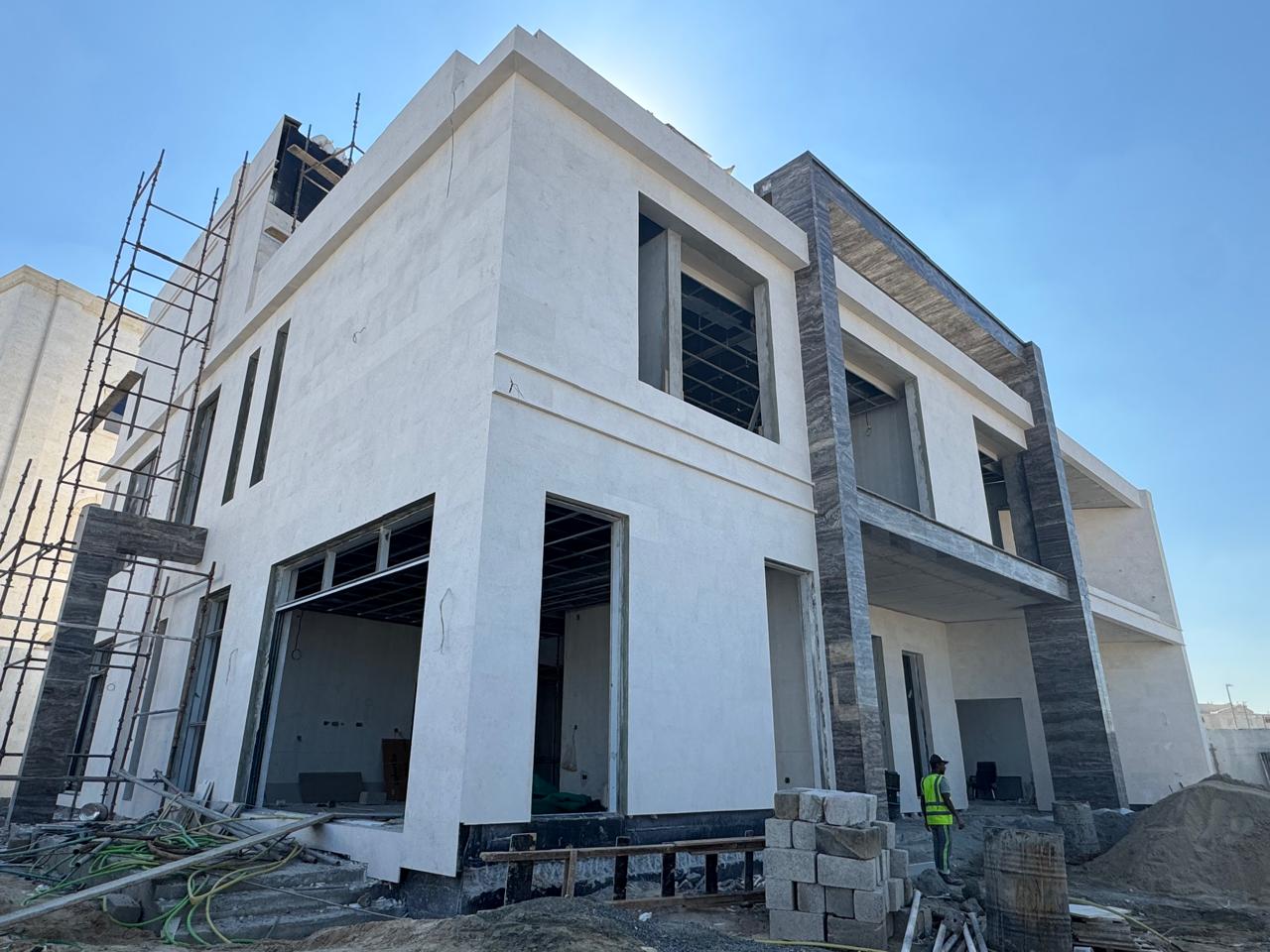 Villa exterior finishing with scaffolding and cladding