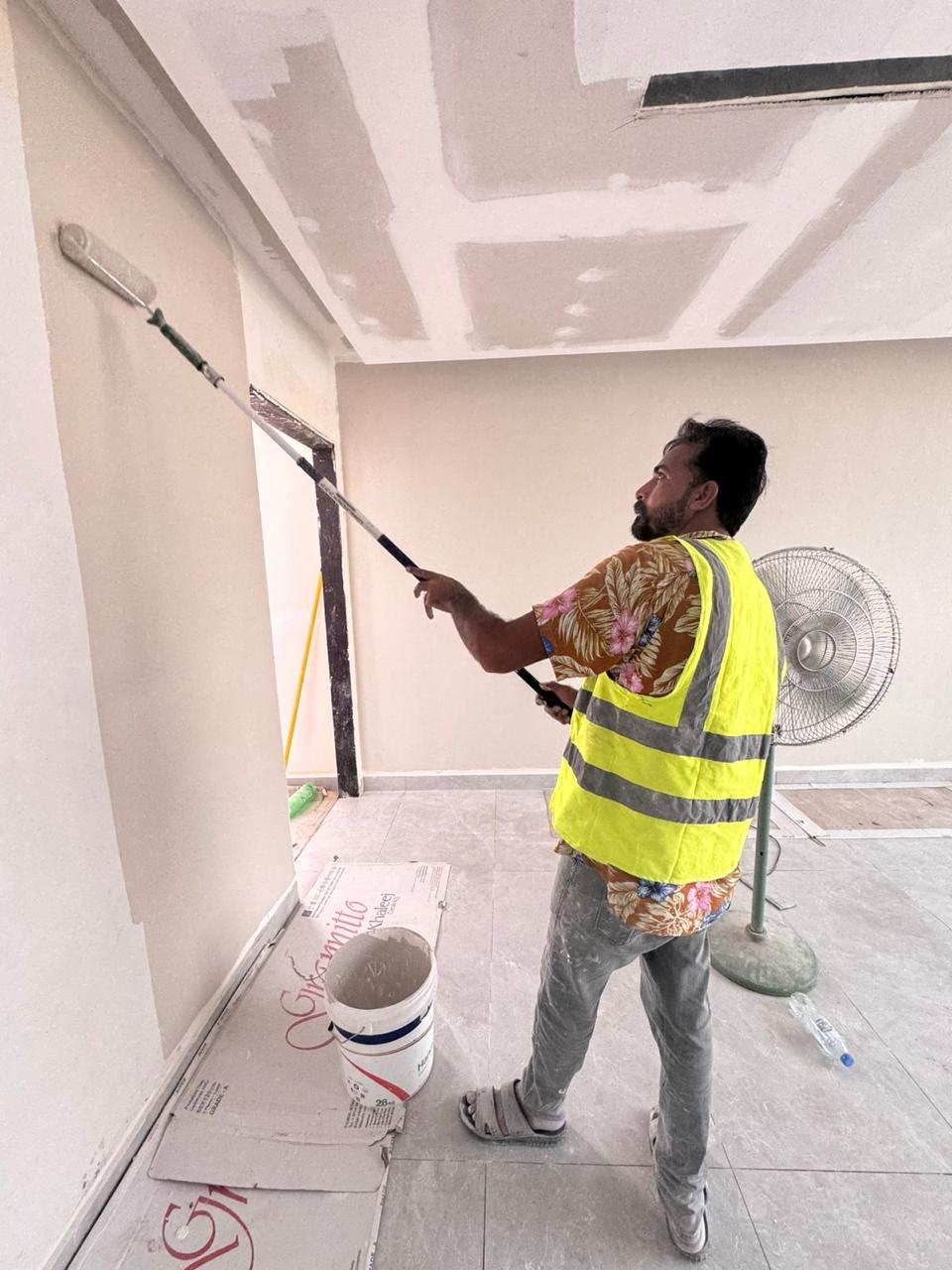 Wall painting with roller in villa finishing works