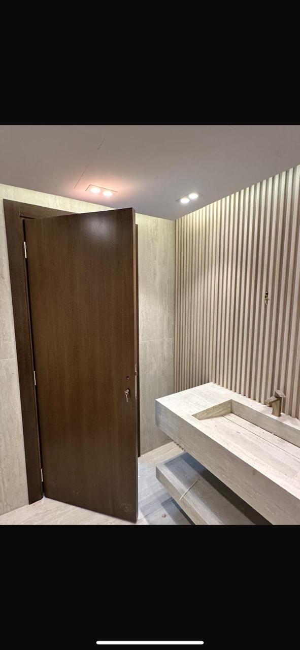 Bathroom door with fluted wall and stone vanity