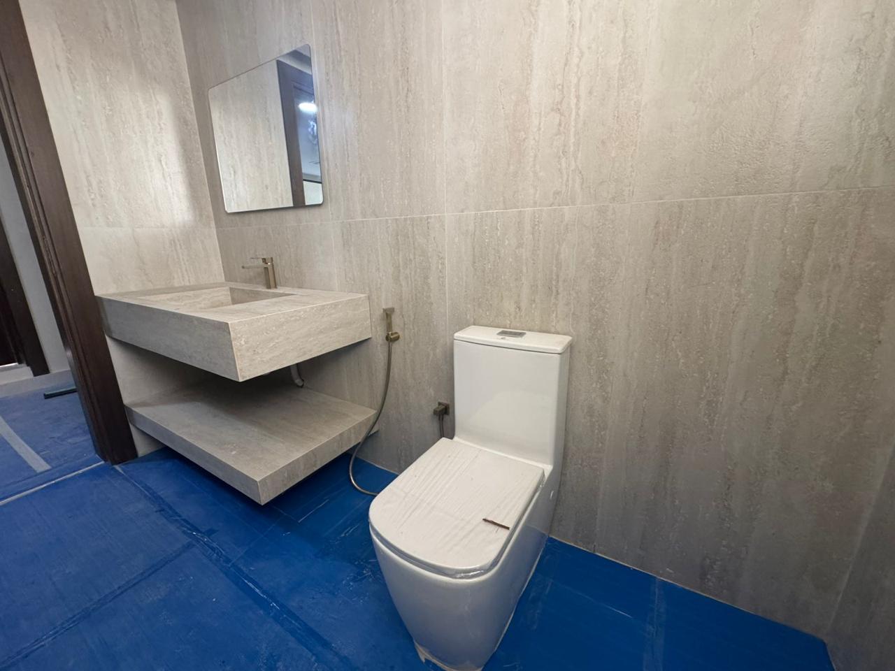 Bathroom vanity and wall tiling with travertine finish