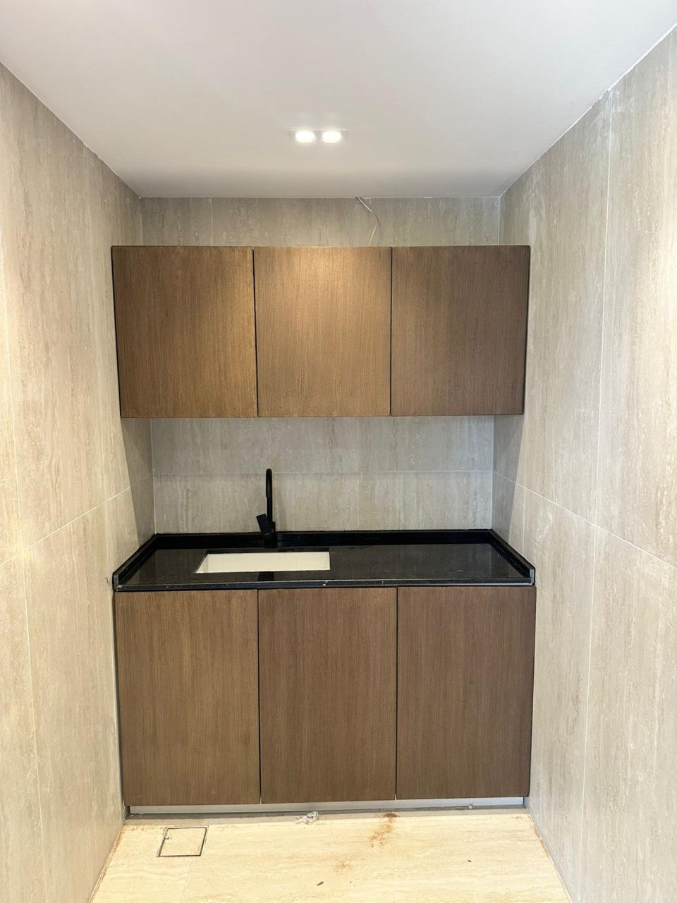 Kitchenette with wood cabinets and granite countertop