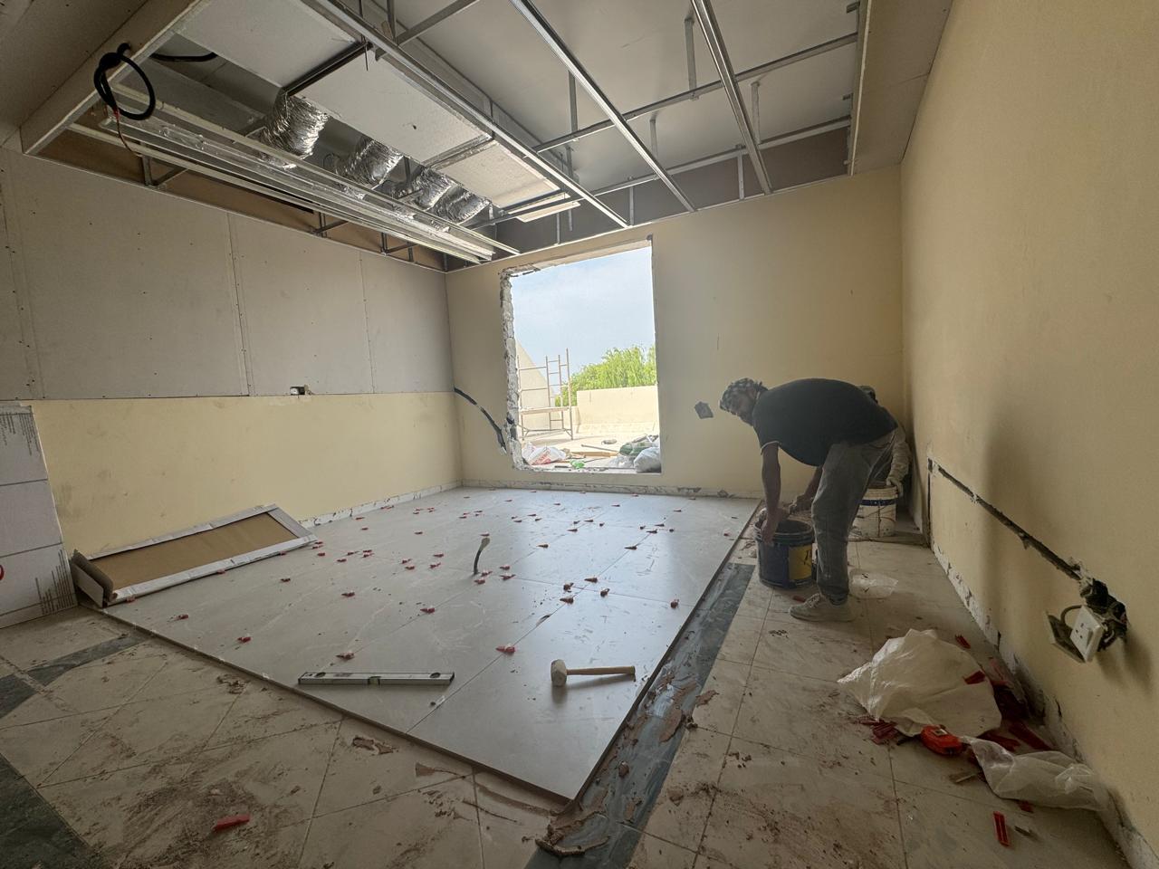 Floor tiling with ceiling grid framework in villa room