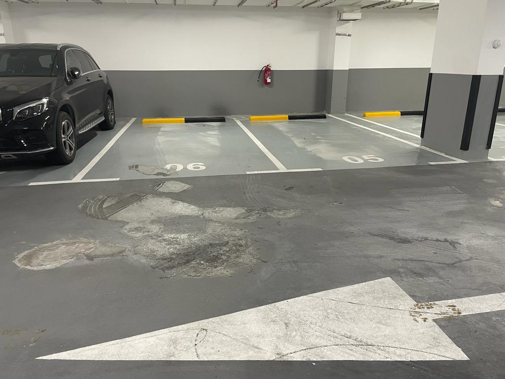 Repaired parking bay area with protective floor coating