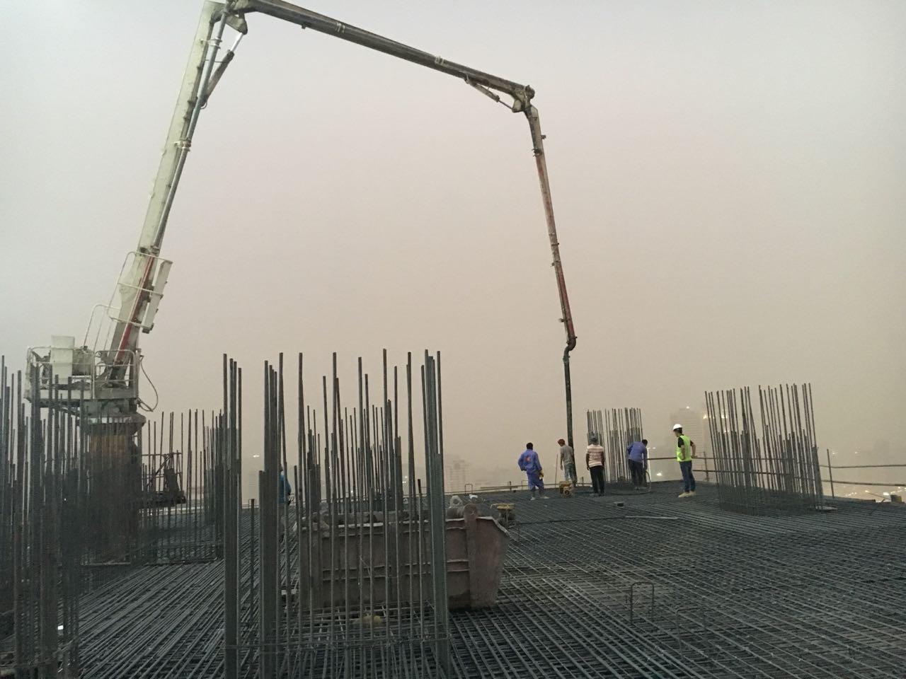 Concrete pump boom pouring slab on site