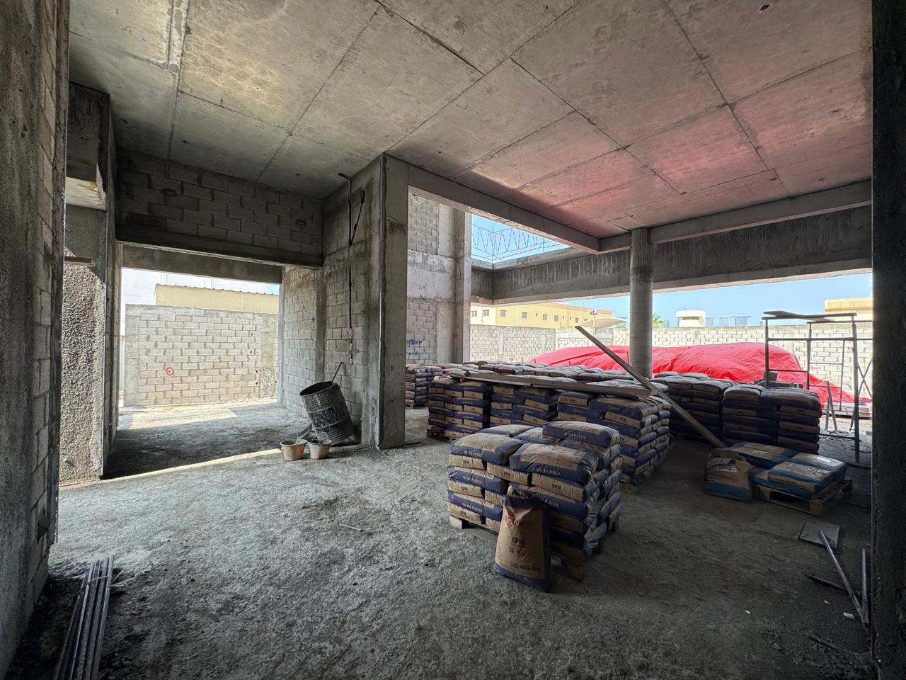 Villa interior with cement bags and blockwork walls