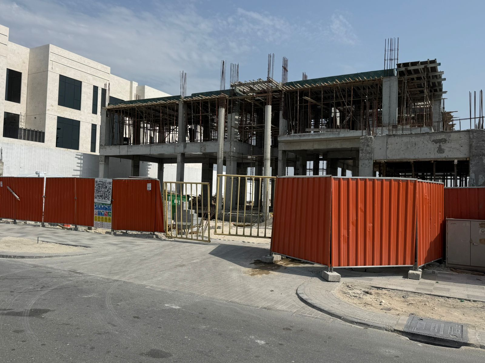 Construction site with hoarding and structural frame