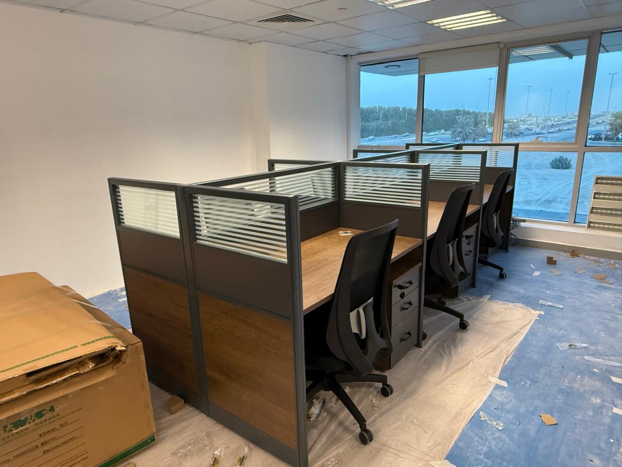 Cubicle workstations row with window view