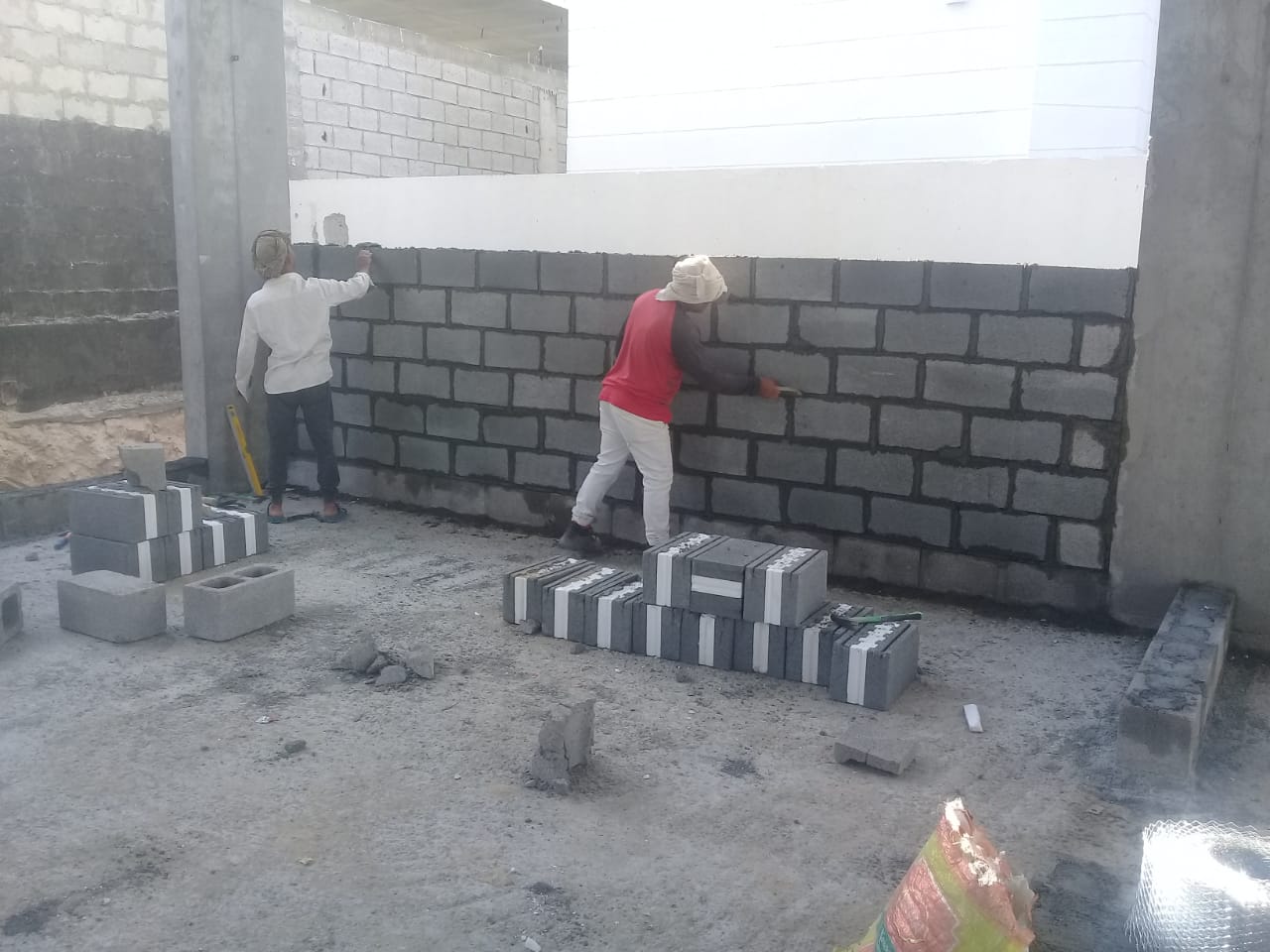 Blockwork wall construction with insulated blocks
