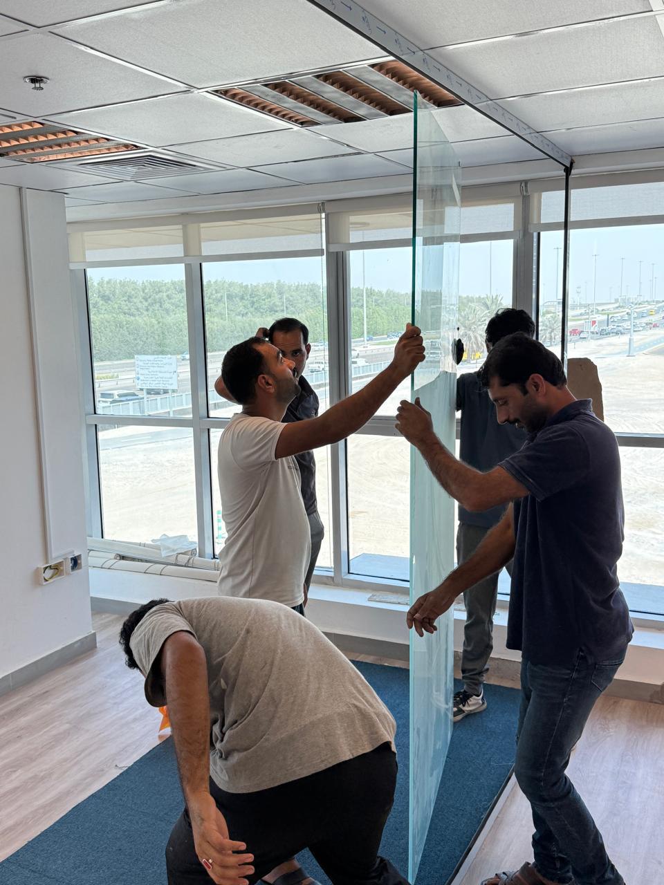 Glass partition panel installation in office