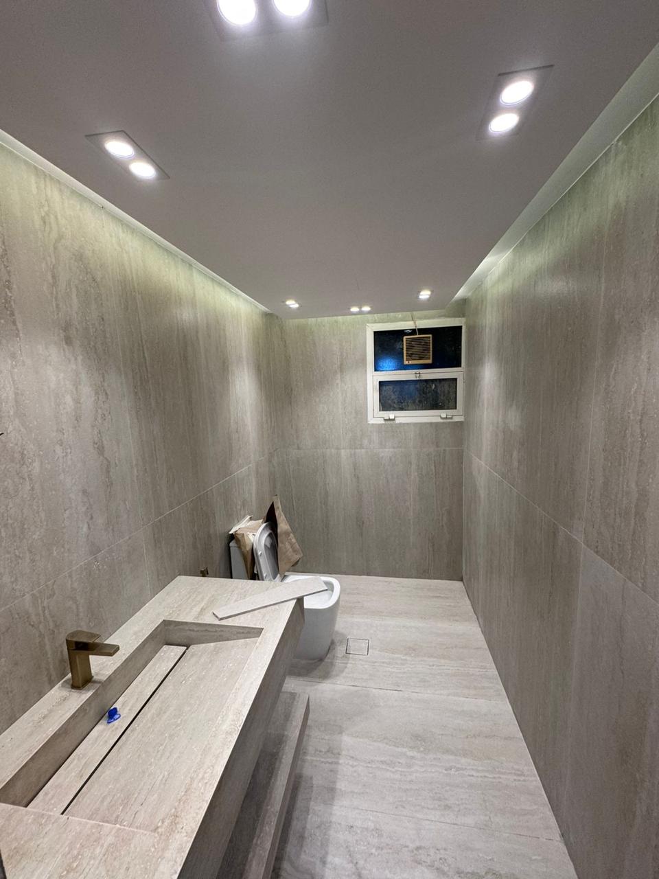 Full stone bathroom with vanity and downlights