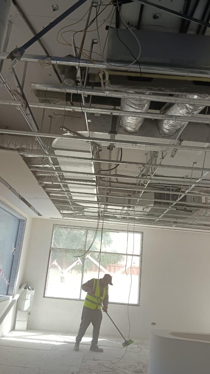 Ceiling duct and grid installation worker in villa fit-out