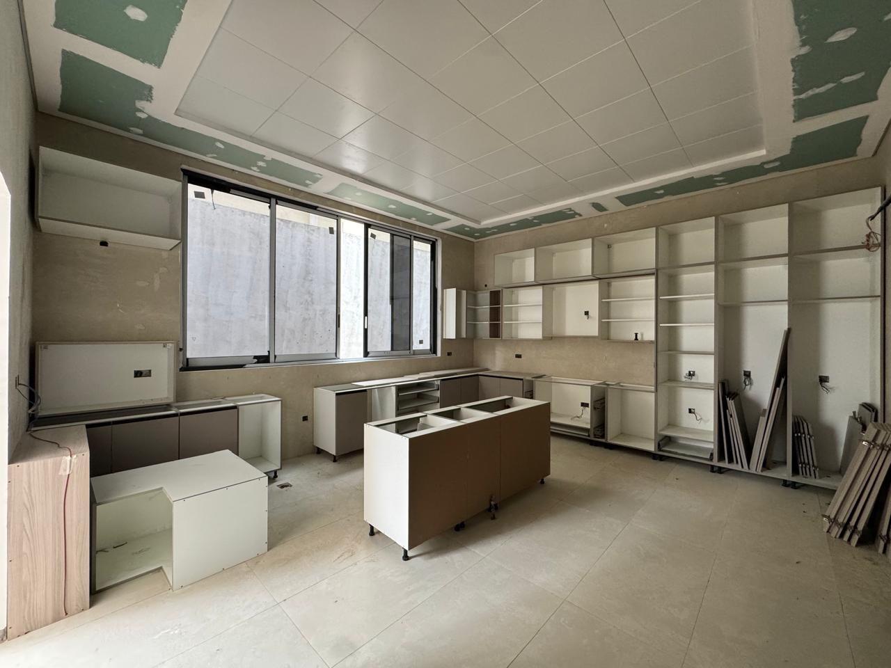 Kitchen joinery and shelving overview during fit-out