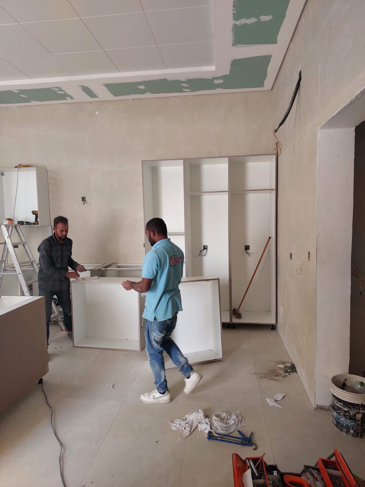 Kitchen joinery assembly team with wardrobe framing