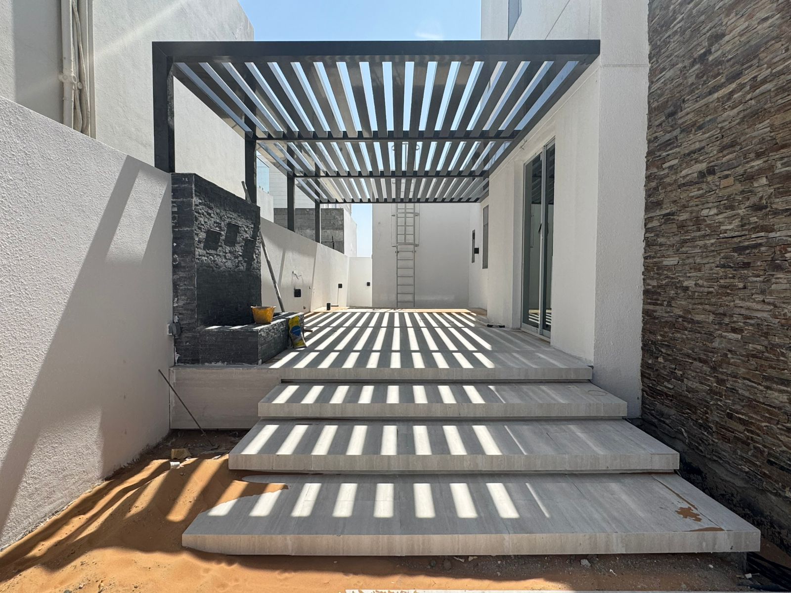 Pergola with stone cladding and steps – villa landscaping Abu Dhabi