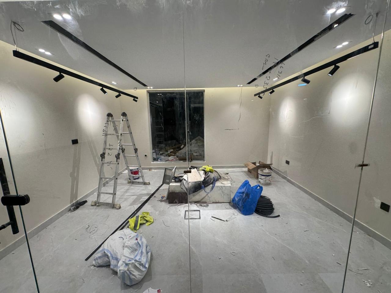 Room with track lighting and glass partition fit-out