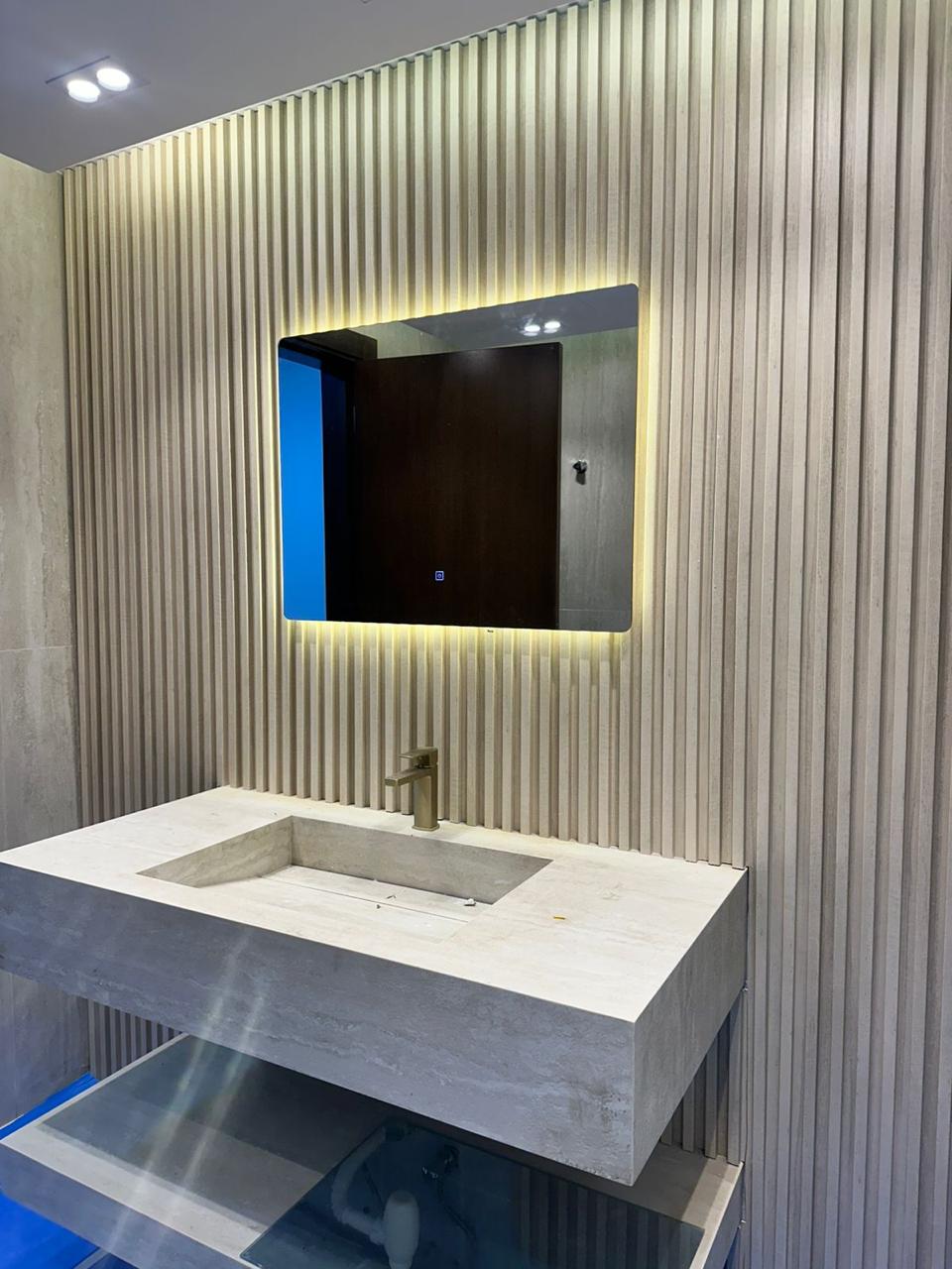 Luxury vanity with fluted wall cladding and LED mirror