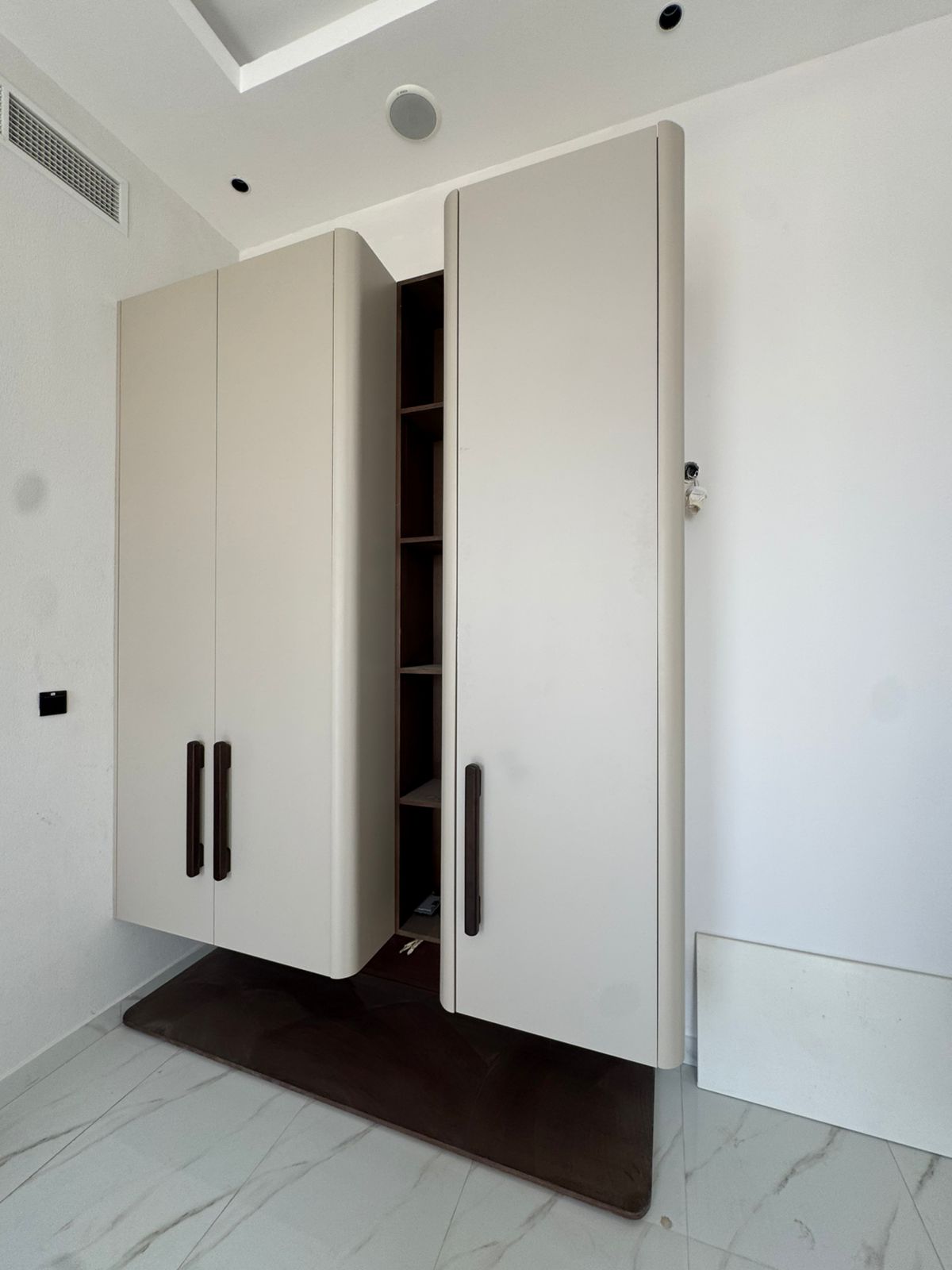 Built-in wardrobe installation with marble flooring