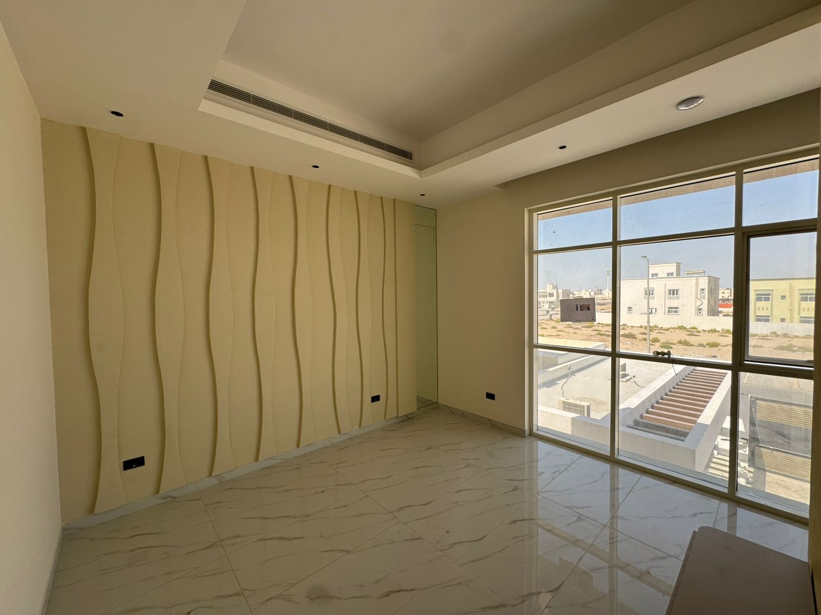 Bedroom with sculptural wave accent wall and false ceiling