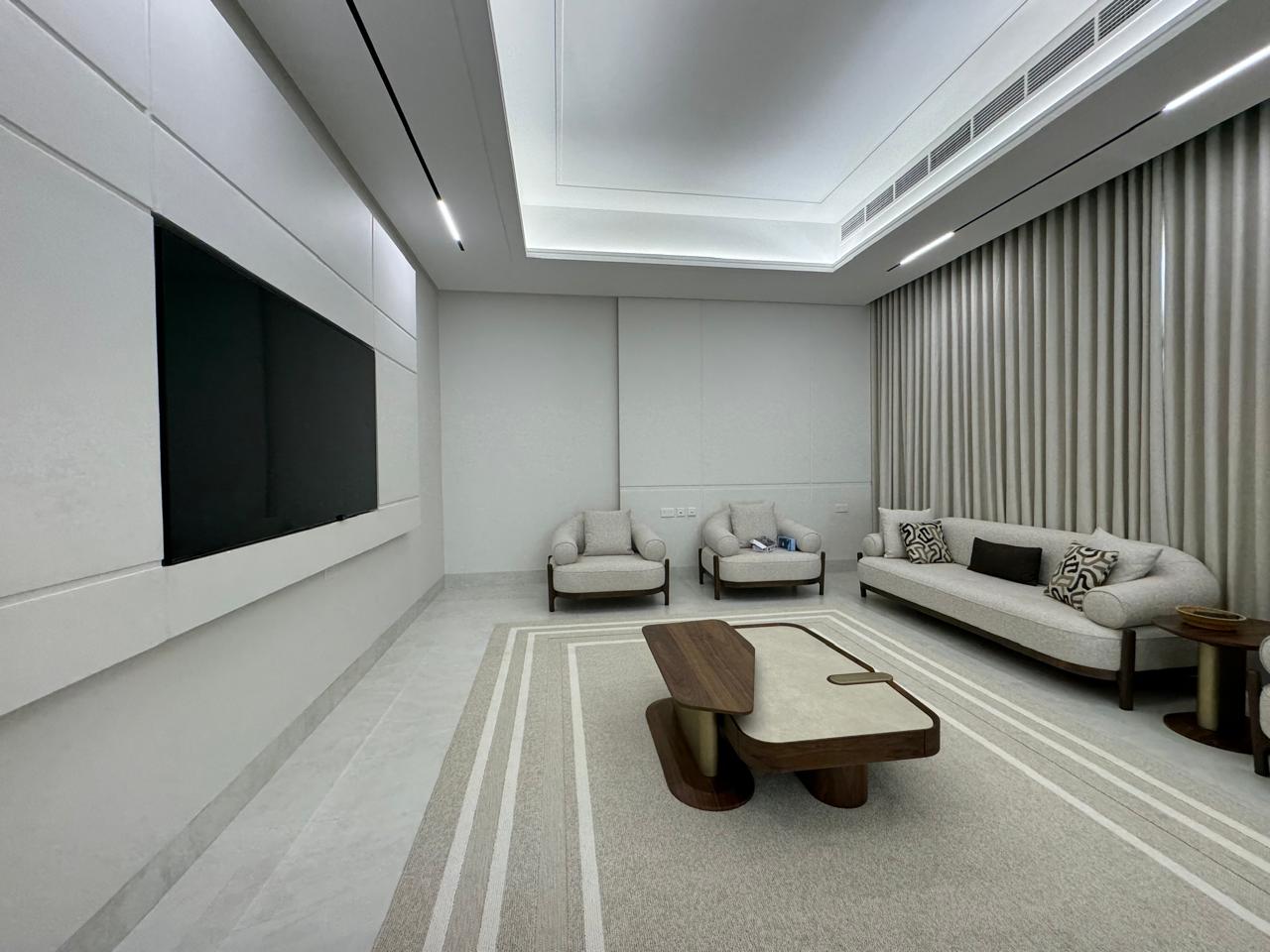 Furnished villa majlis with TV wall and designer seating