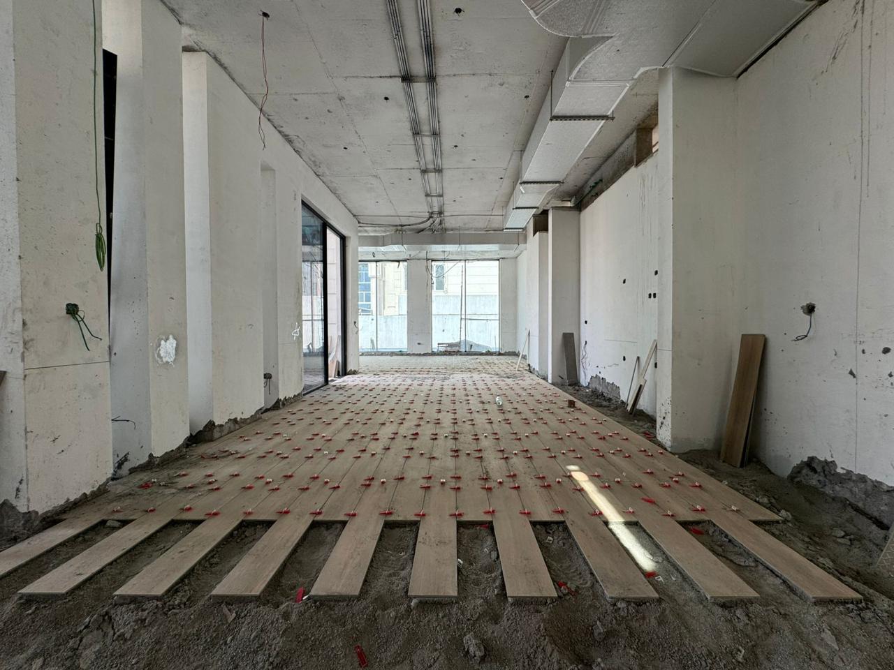 Commercial floor tiling installation with spacers
