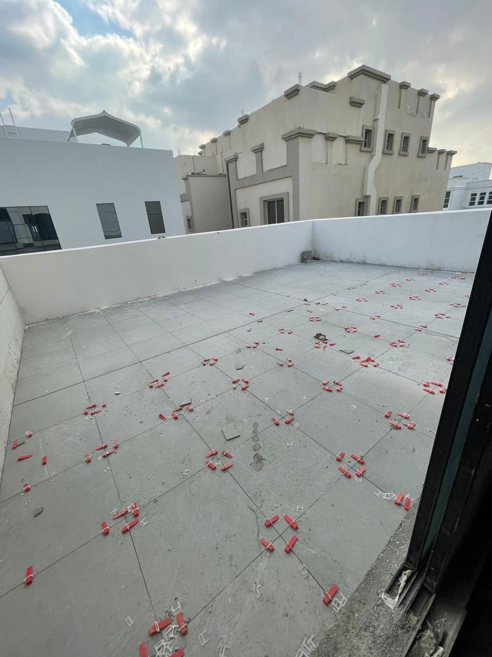 Rooftop terrace floor tiling with leveling spacers