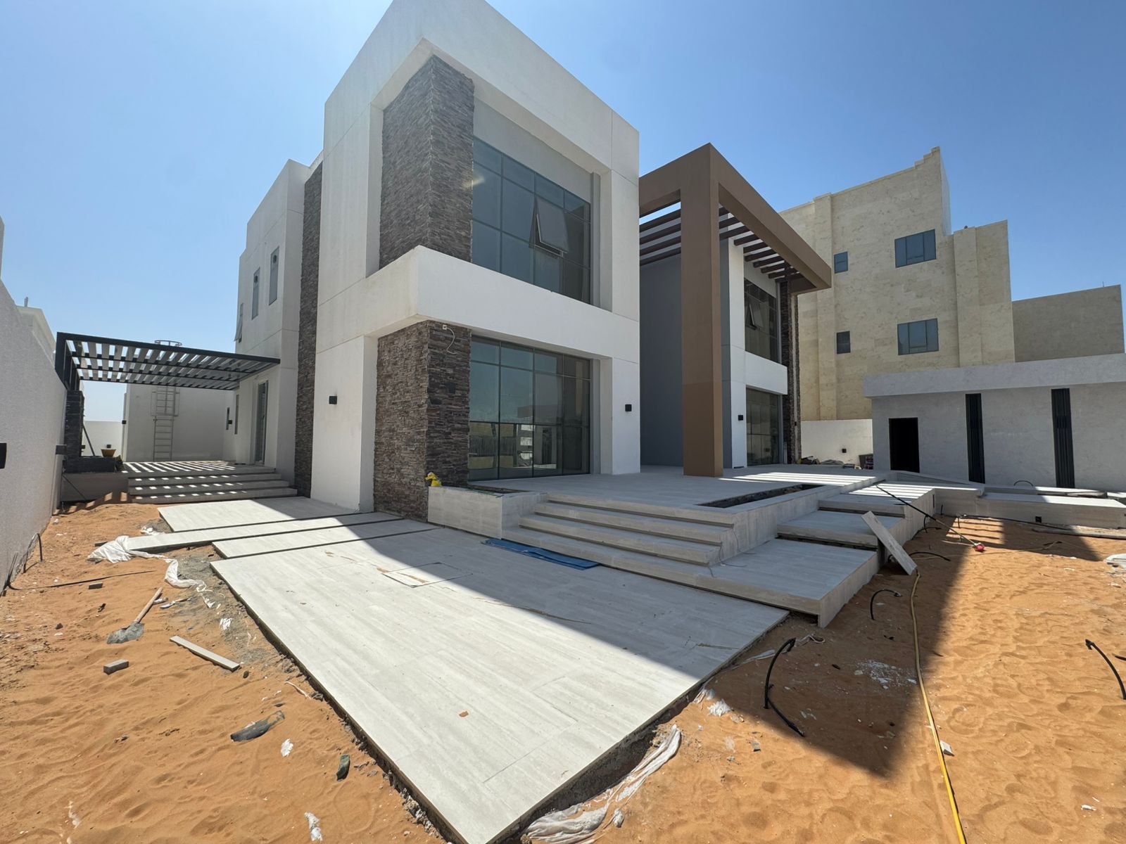 Villa front facade with stone cladding and hardscaping Abu Dhabi