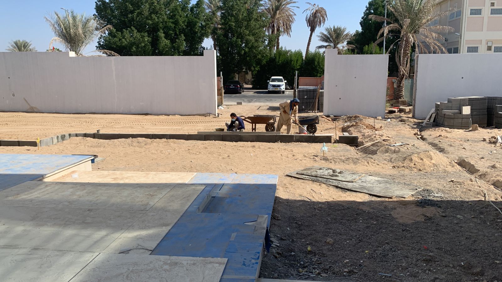 Landscaping workers laying interlock pavers Abu Dhabi