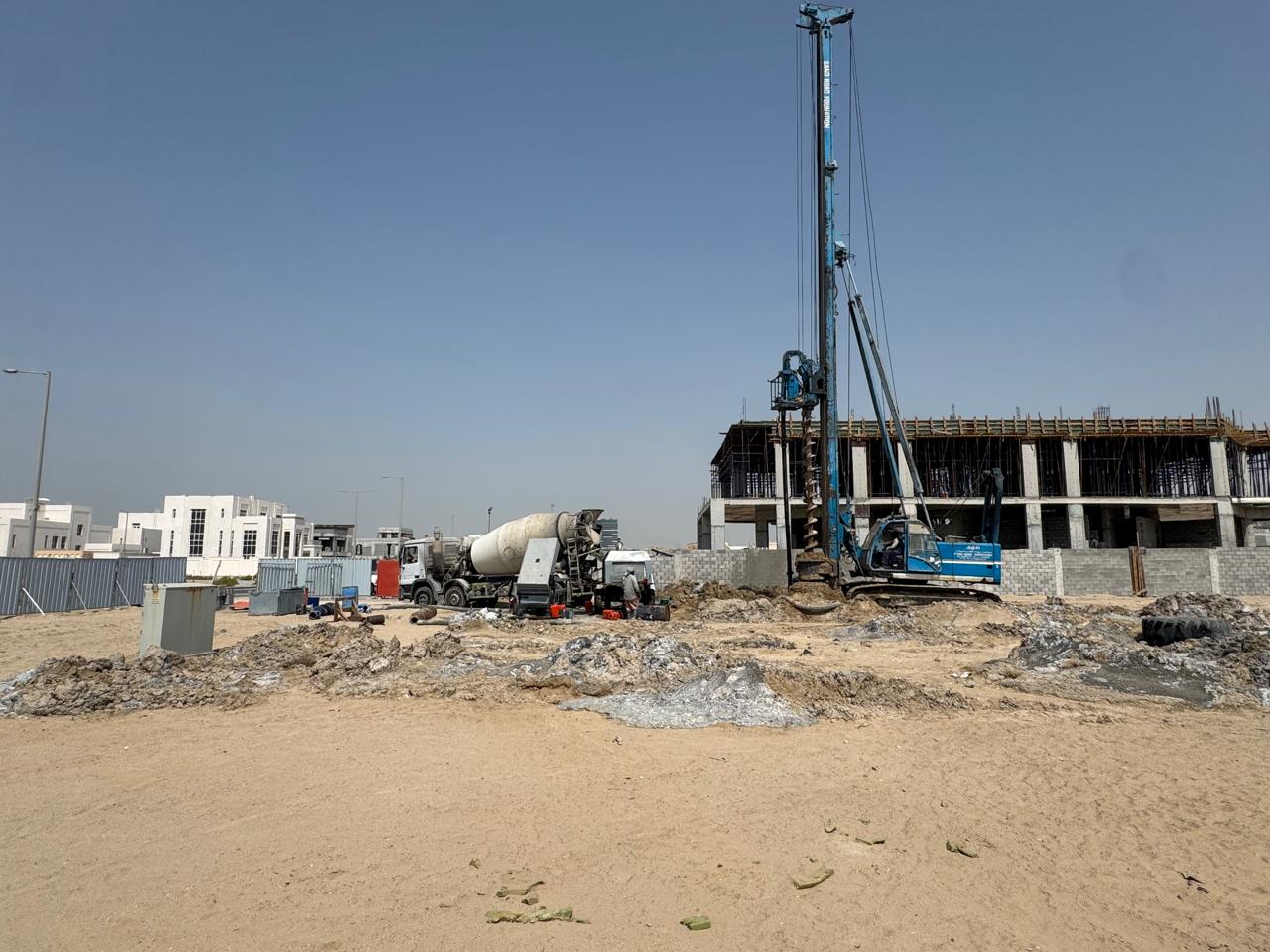 Piling rig with concrete mixer on site