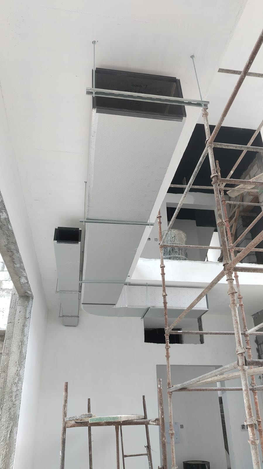 HVAC duct branch installation with scaffolding in villa