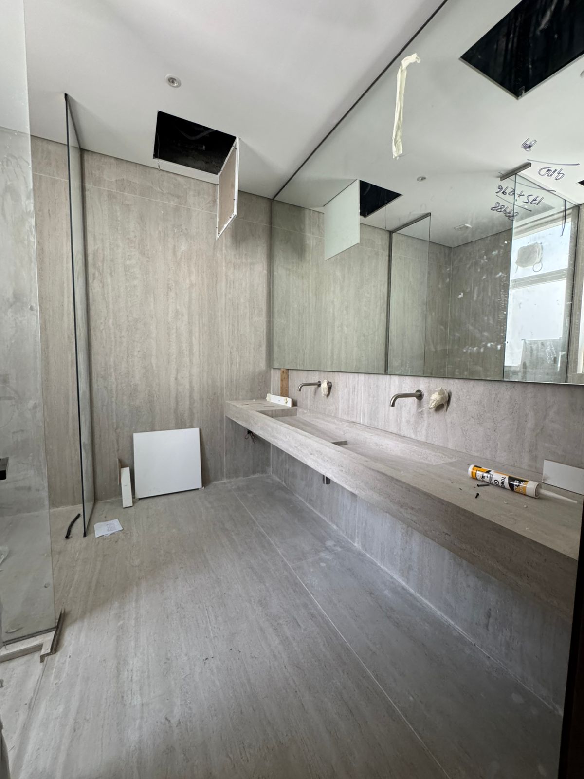 Luxury bathroom with stone vanity and wall-mounted taps