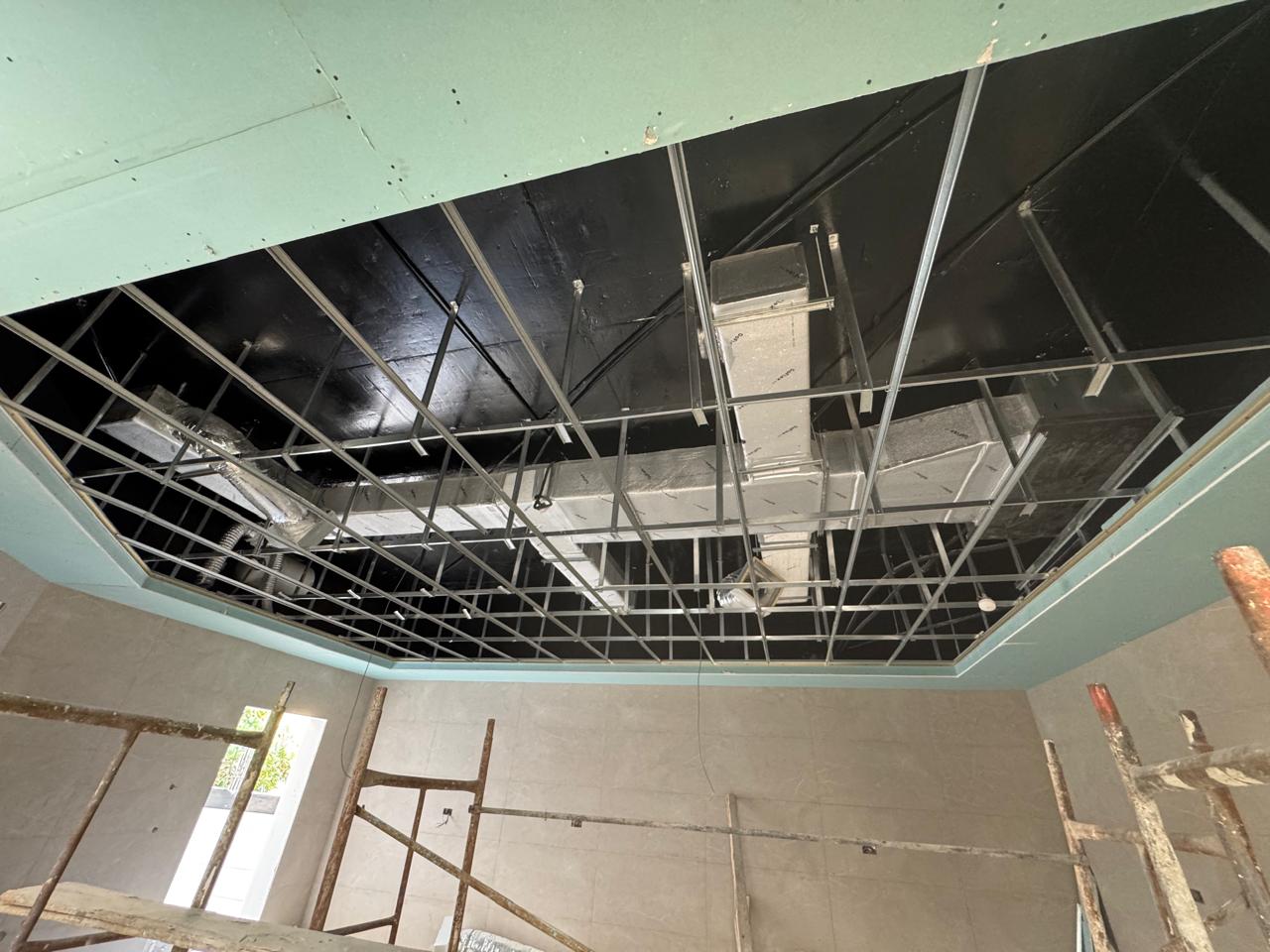 Ceiling grid and duct installation with scaffolding in villa