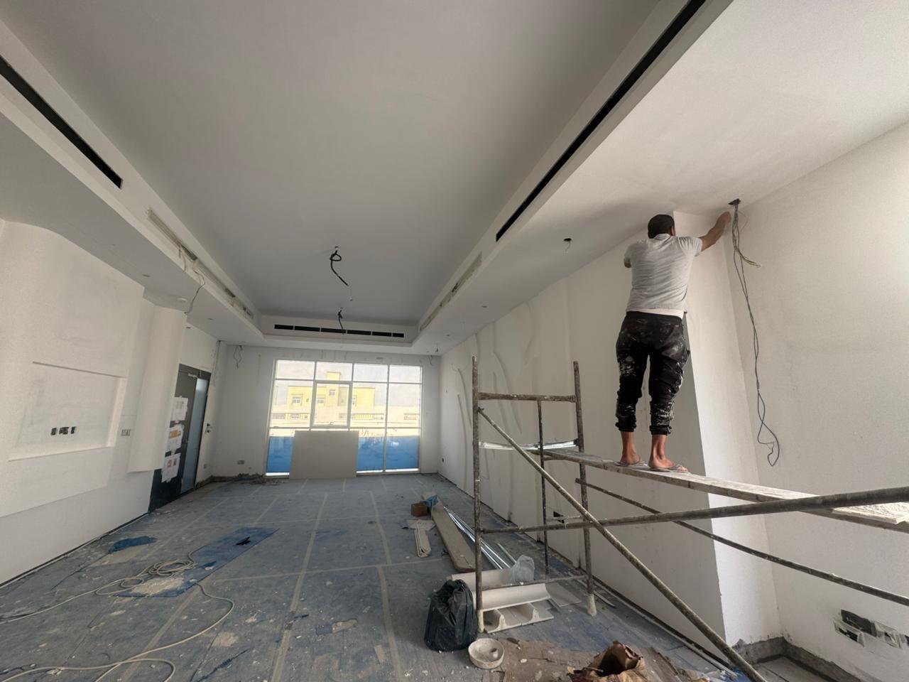 Workers finishing gypsum feature wall