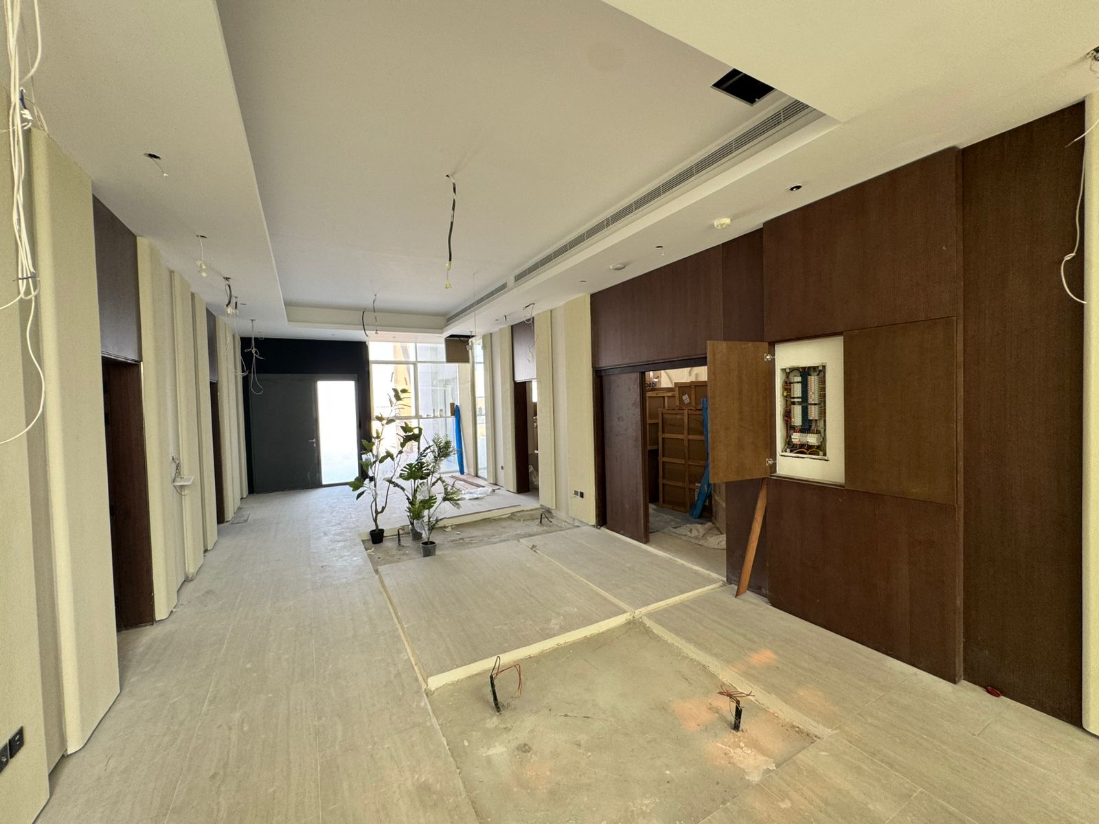 Villa lobby fit-out with wood cladding and DB panel