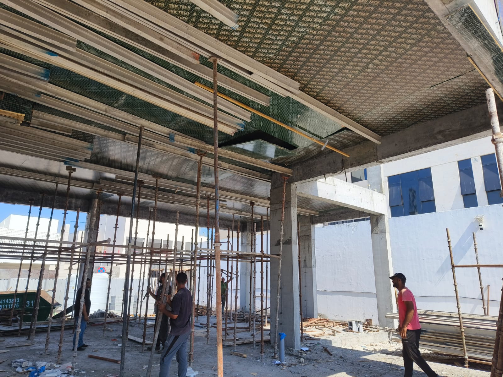 Construction workers on formwork site with safety equipment Abu Dhabi