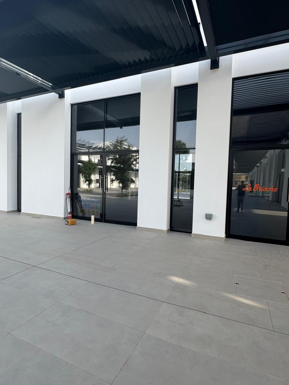 Building facade exterior with full-height glazing and canopy
