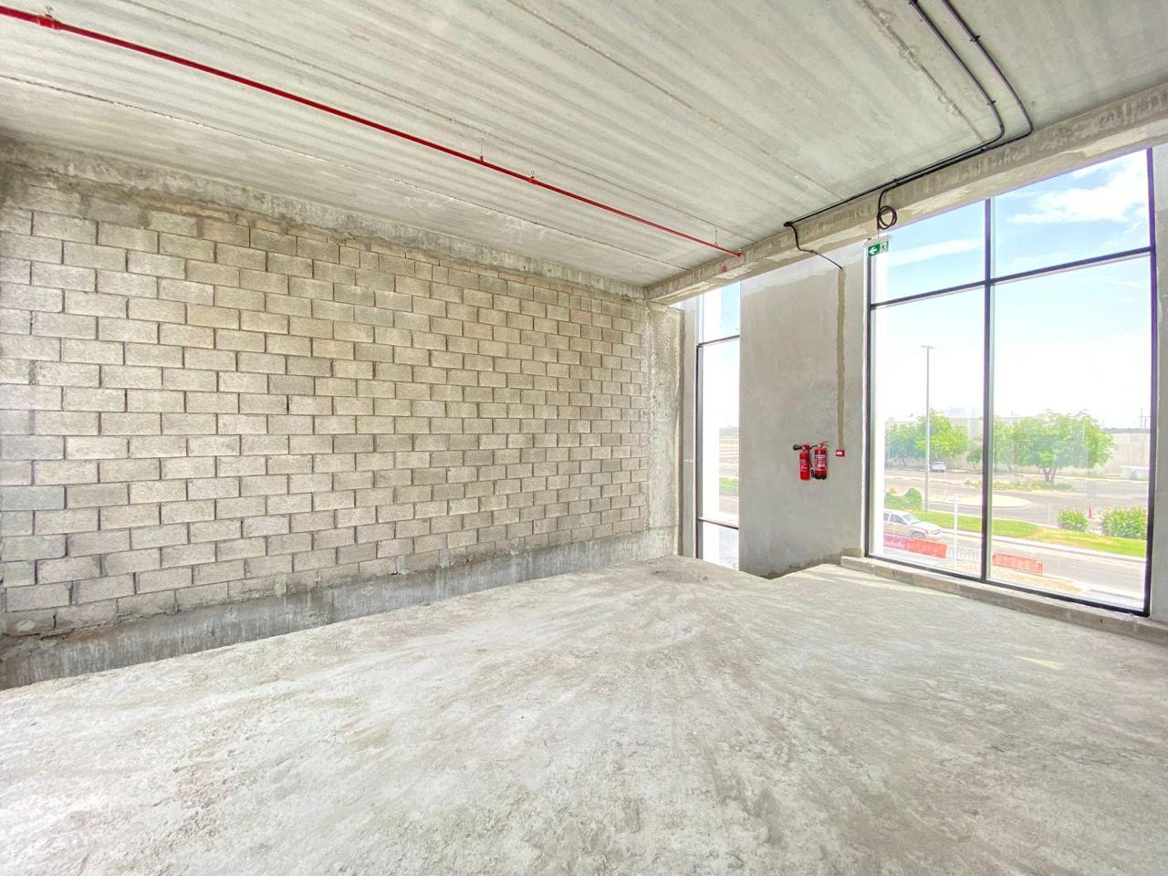 Shell interior with blockwork wall and fire extinguishers by window