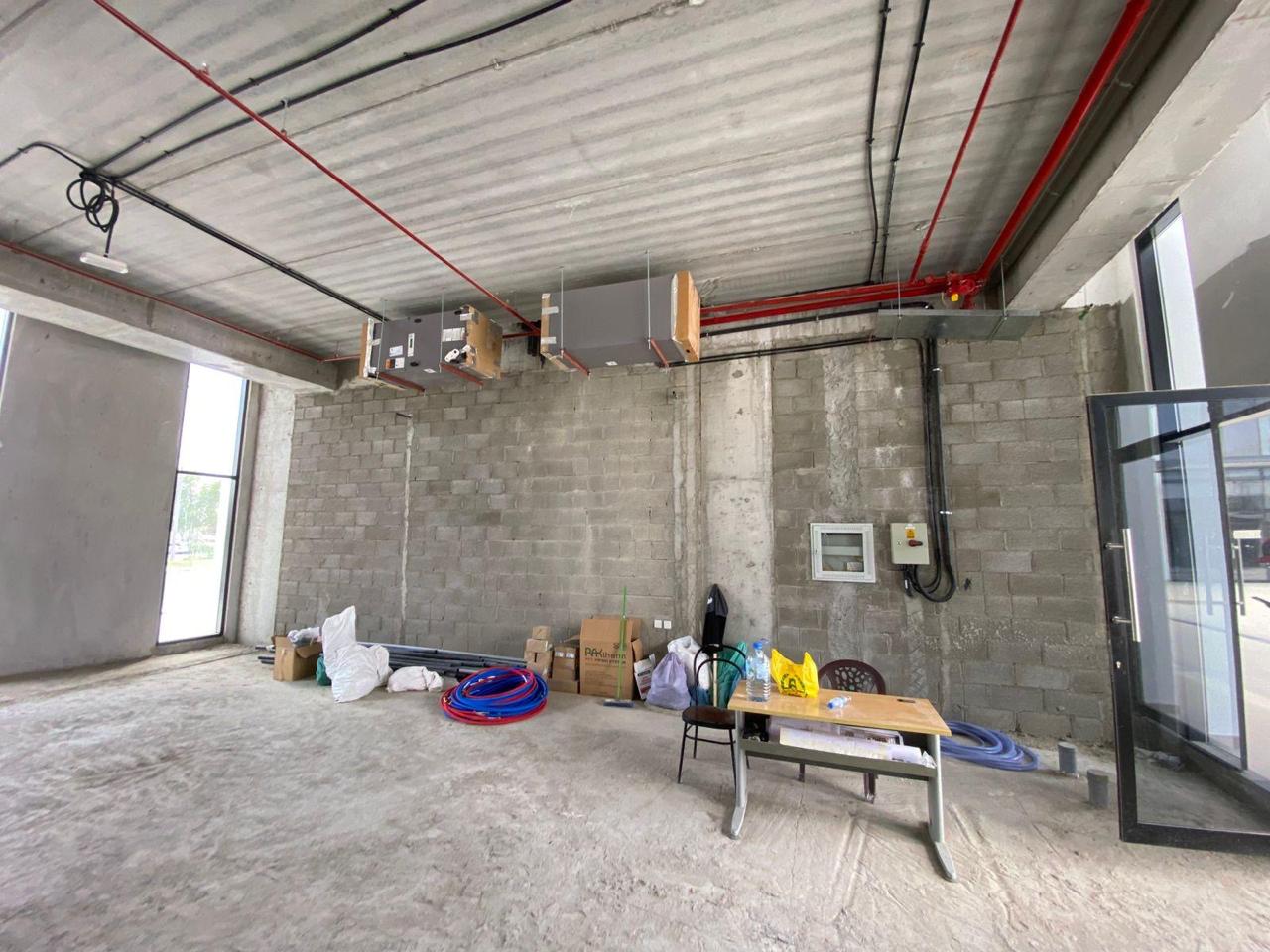 Shell space with HVAC units, materials, and electrical panel